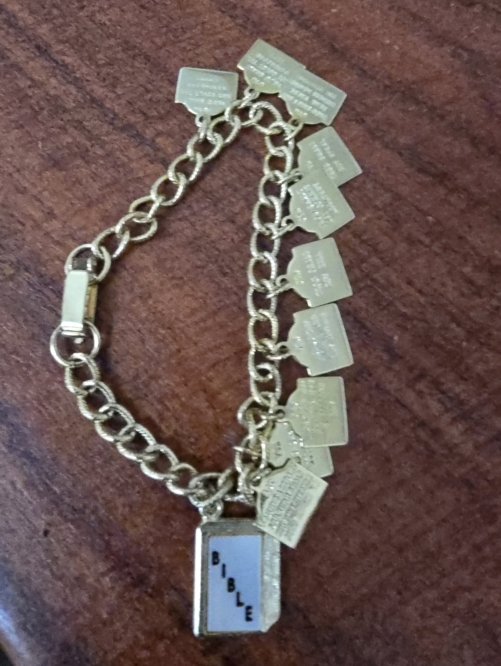 Gold Charm Bracelet with Bible Book Charm And 10 Commandments Charms 7 In. Long.